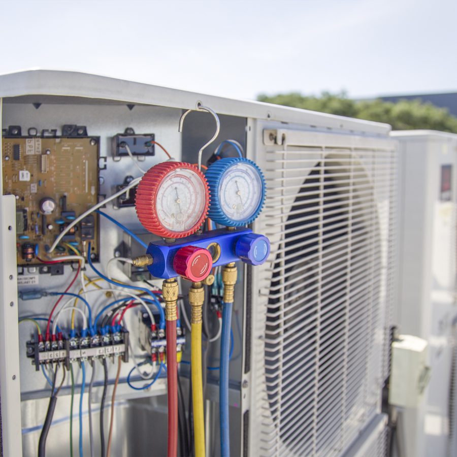 air-conditioning-hvac-service-technician-using-gauges-check-refrigerant-add-refrigerant